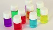 Nine transparent bottles spins with color oil