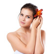 Skincare of young beautiful woman face with fresh flower