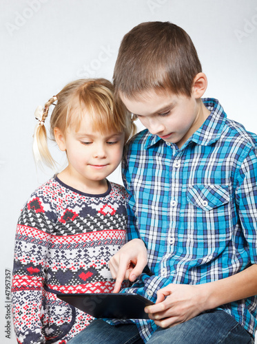 Photo: Children playing with a tablet computer Children playing with a tablet computer