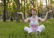 The woman meditates in park