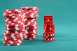 Red poker gambling chips on a green playing table