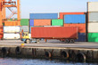 Foto: Container truck runs at port warehouse Container truck runs at port warehouse