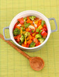 Vegetable stew in gray pot on bamboo mat background