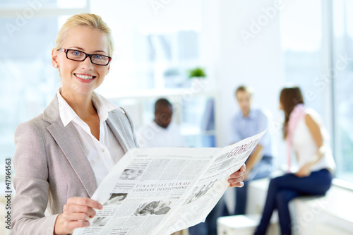 Photo: Female reading newspaper Female reading newspaper