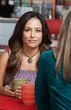 Hispanic Woman with Friend in Cafe