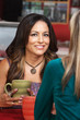 Smiling Woman with Friend in Cafe