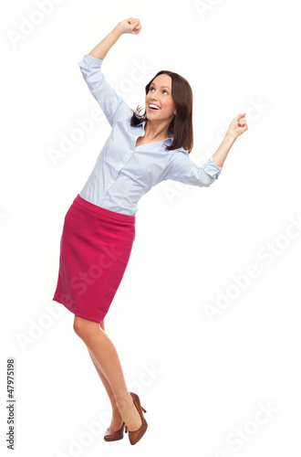 Photo: Happy businesswoman clenching fists Happy businesswoman clenching fists