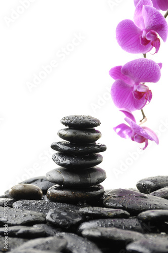Photo: Zen abstract of Stack stones in balance with pink orchid Zen abstract of Stack stones in balance with pink orchid