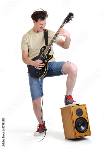 Photo: Man in shorts with an electric guitar on white background Man in shorts with an electric guitar on white background