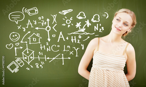 Photo: portrait of young teacher near blackboard portrait of young teacher near blackboard