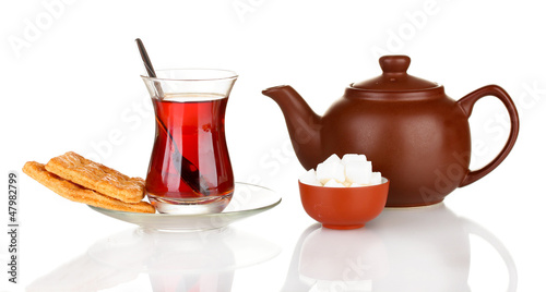 Photo: glass of Turkish tea and kettle isolated on white glass of Turkish tea and kettle isolated on white