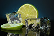 Ice cubes with lime on darck blue background