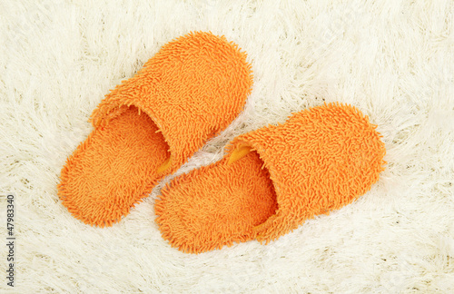 Photo: bright slippers, on carpet background bright slippers, on carpet background