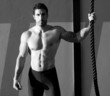 Crossfit gym man holding hand a climbing rope