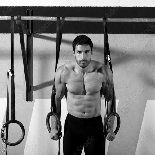 Photo: Crossfit dip ring man workout at gym Crossfit dip ring man workout at gym