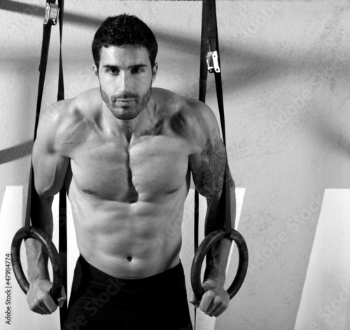 Photo: Crossfit dip ring man workout at gym Crossfit dip ring man workout at gym
