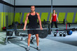 gym with weight lifting bar workout man and woman
