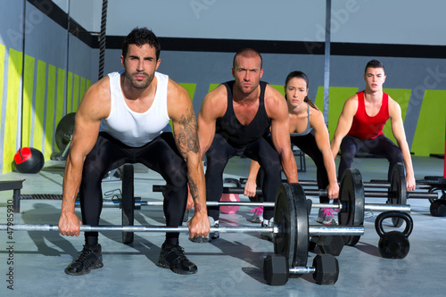 Photo: gym group with weight lifting bar crossfit workout gym group with weight lifting bar crossfit workout