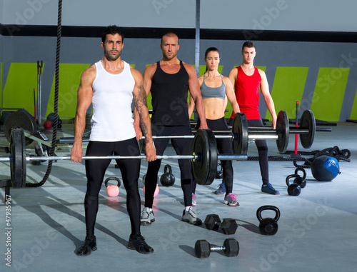 Photo: gym group with weight lifting bar crossfit workout gym group with weight lifting bar crossfit workout