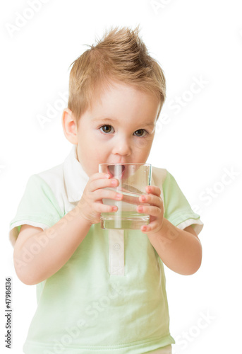 Photo: Boy drinking water from glass isolated on white Boy drinking water from glass isolated on white