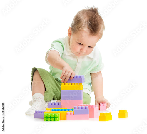 Photo: Kid playing colorful toy building blocks Kid playing colorful toy building blocks