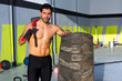 Crossfit sledge hammer man at gym relaxed
