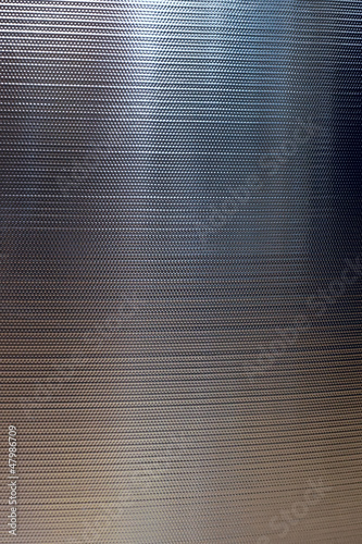 Photo: Metal textured wall reflecting light. Metal textured wall reflecting light.
