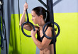 Crossfit dip ring woman relaxed after workout at gym