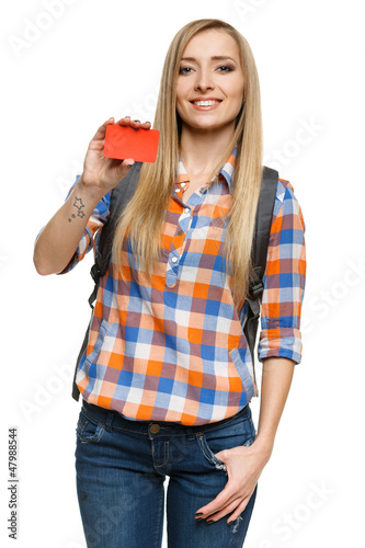 Photo: Smiling female with backpack holding empty credit card Smiling female with backpack holding empty credit card