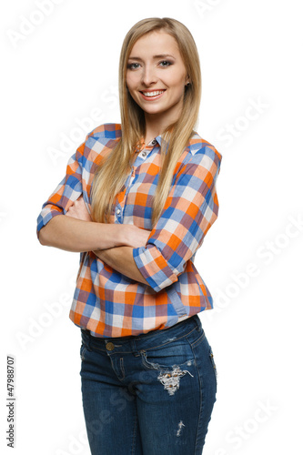 Photo: Young smiling female standing with hands folded Young smiling female standing with hands folded