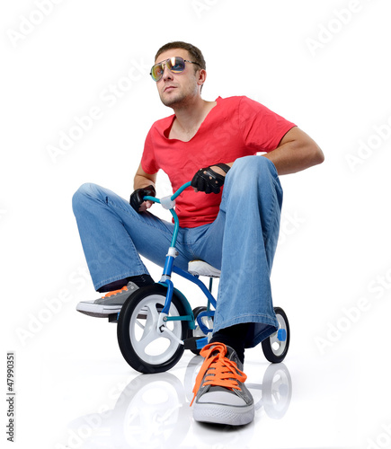 Photo: Man on a children's bicycle, on white background Man on a children's bicycle, on white background