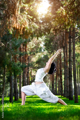 Photo: Yoga warrior pose in the park Yoga warrior pose in the park