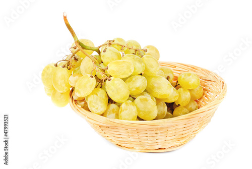 Photo: Fresh grapes in Fruit Basket isolated on white background Fresh grapes in Fruit Basket isolated on white background
