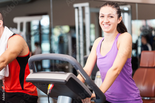 Photo: Woman training in a fitness club Woman training in a fitness club