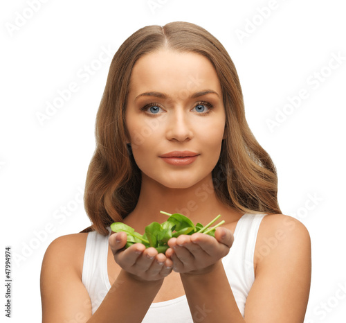 Photo: woman with spinach leaves on palms woman with spinach leaves on palms