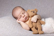sleeping baby with teddy bear