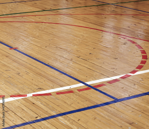 Photo: Wooden floor of sports hall with colorful marking lines Wooden floor of sports hall with colorful marking lines