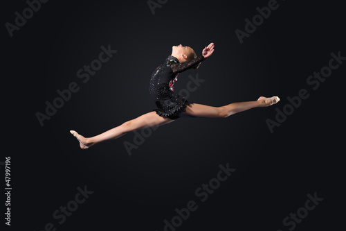 Photo: Young woman in gymnast suit posing Young woman in gymnast suit posing