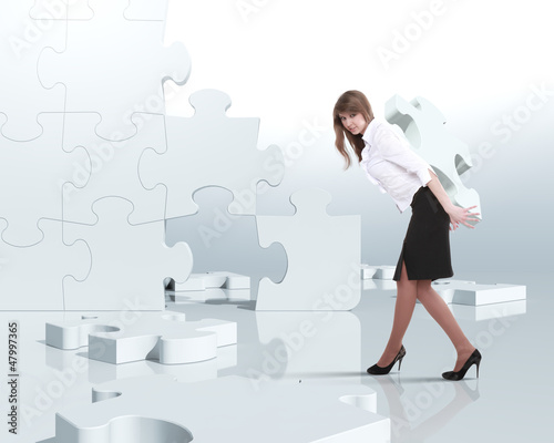 Photo: Businesswoman with a puzzle pieces Businesswoman with a puzzle pieces