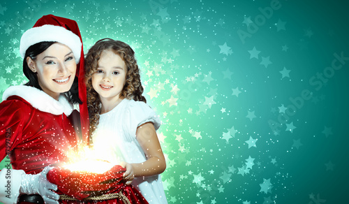 Photo: Little girl with christmas gifts and santa Little girl with christmas gifts and santa