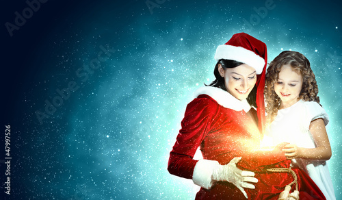 Photo: Little girl with christmas gifts and santa Little girl with christmas gifts and santa