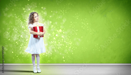 Photo: Happy girl opening gift box Happy girl opening gift box