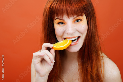 Photo: girl with slice of orange girl with slice of orange