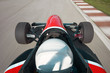 Red bolide driving at high speed in circuit.Camera on board