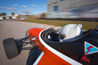 Red bolide driving at high speed in circuit.Camera on board