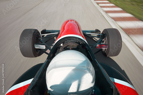 Photo: Red bolide driving at high speed in circuit.Camera on board Red bolide driving at high speed in circuit.Camera on board