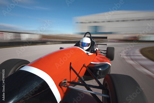 Photo: Red bolide driving at high speed in circuit.Camera on board view Red bolide driving at high speed in circuit.Camera on board view