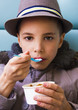 Photo: Cute teenage boy eating ice cream with chocolate topping Cute teenage boy eating ice cream with chocolate topping