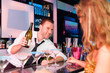 Young woman in club or bar drinking champagne