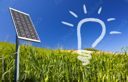 Photo: Ecological renewable solarpanel over greenfield and blue sky Ecological renewable solarpanel over greenfield and blue sky